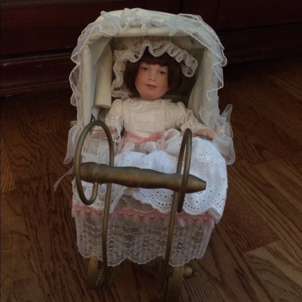 Vintage porcelain doll in stroller